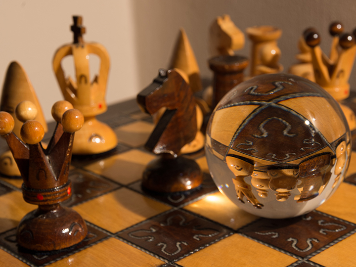 Crystal ball on a wooden chessboard