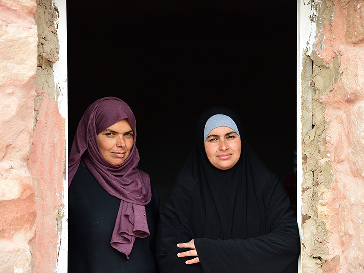 Jordanian women standing in front of a door in Petra