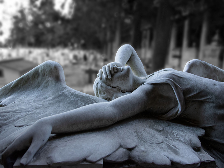 A classical angel statue in Staglieno cemetery in Genoa, Italy